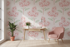 Room interior with pink floral wallpaper, a desk, and a chair.